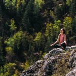 Attractive woman doing yoga. Healthy lifestyle. Woman doing yoga in the mountains.