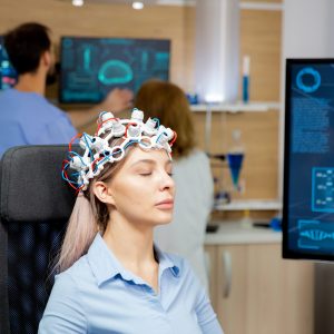 Female patient scanning her brain with neurology headset