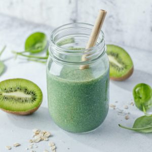 Green smoothie in jar on table