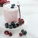 homemade yogurt with berries in a glass. blueberries and cranberry